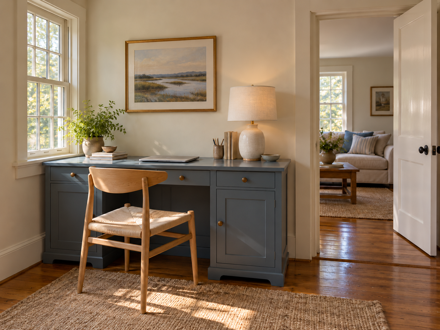 A closed-storage desk placed beside a doorway so work can be put away when the room changes use.
